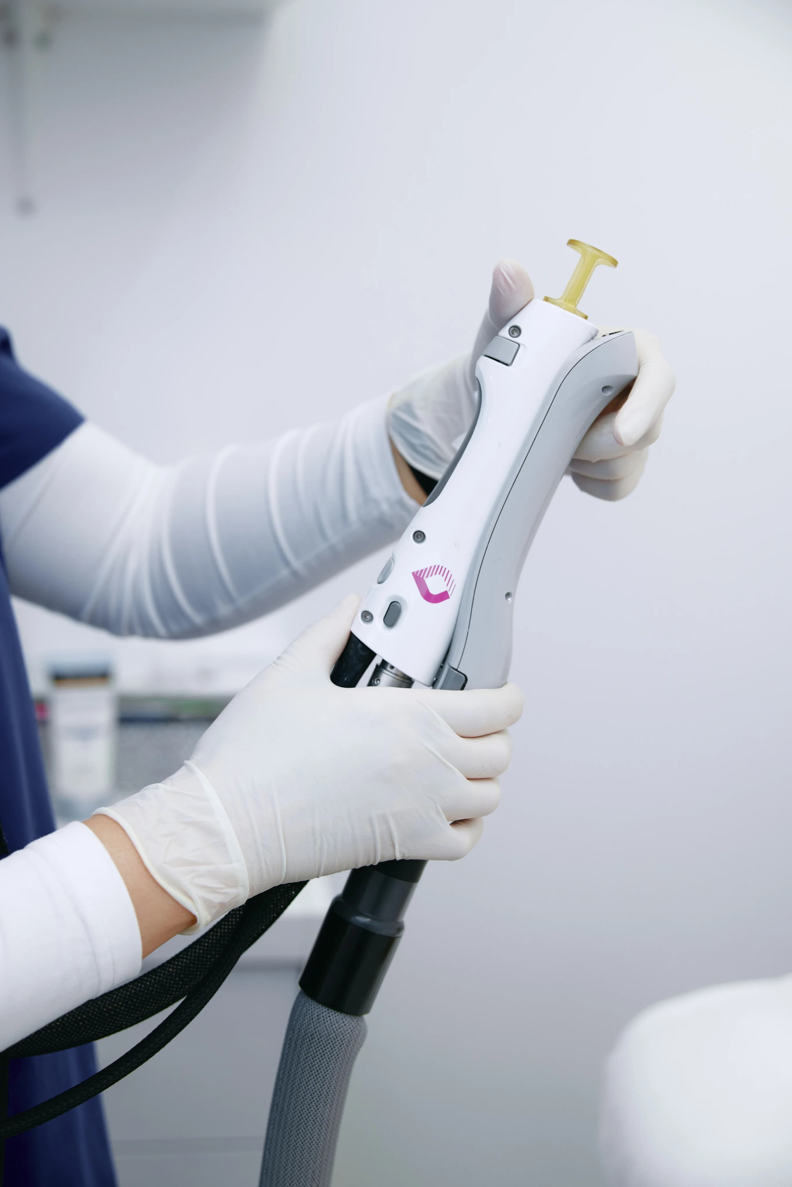 Close-up of a hand holding a laser hair removal device.